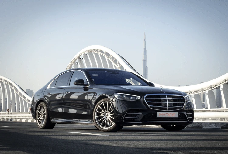 Mercedes-Benz S-Class limousine on Meydan Bridge with the Burj Khalifa in the background, Dubai
